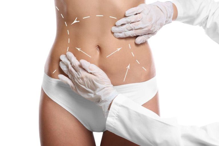 Surgeon examining female body before plastic operation